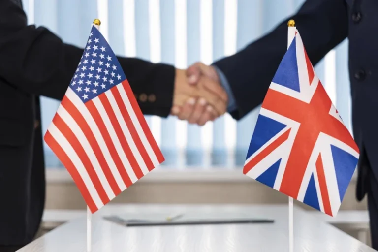 Flag US and UK hands shaking agreement concept